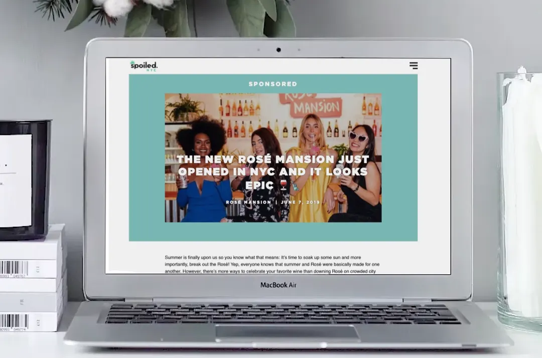 A laptop shows a sponsored spoiled NYC article, "The New Rosé Mansion Just Opened in NYC and It Looks Epic," dated June 7, 2019.